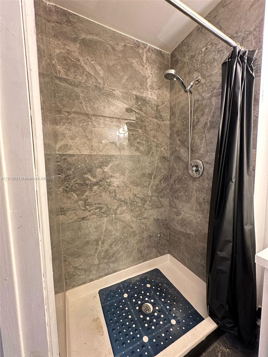 861 Northeast 209th Terrace, Unit 203 Miami, FL 33179 - Photo 12 of 16 a bathroom with a shower