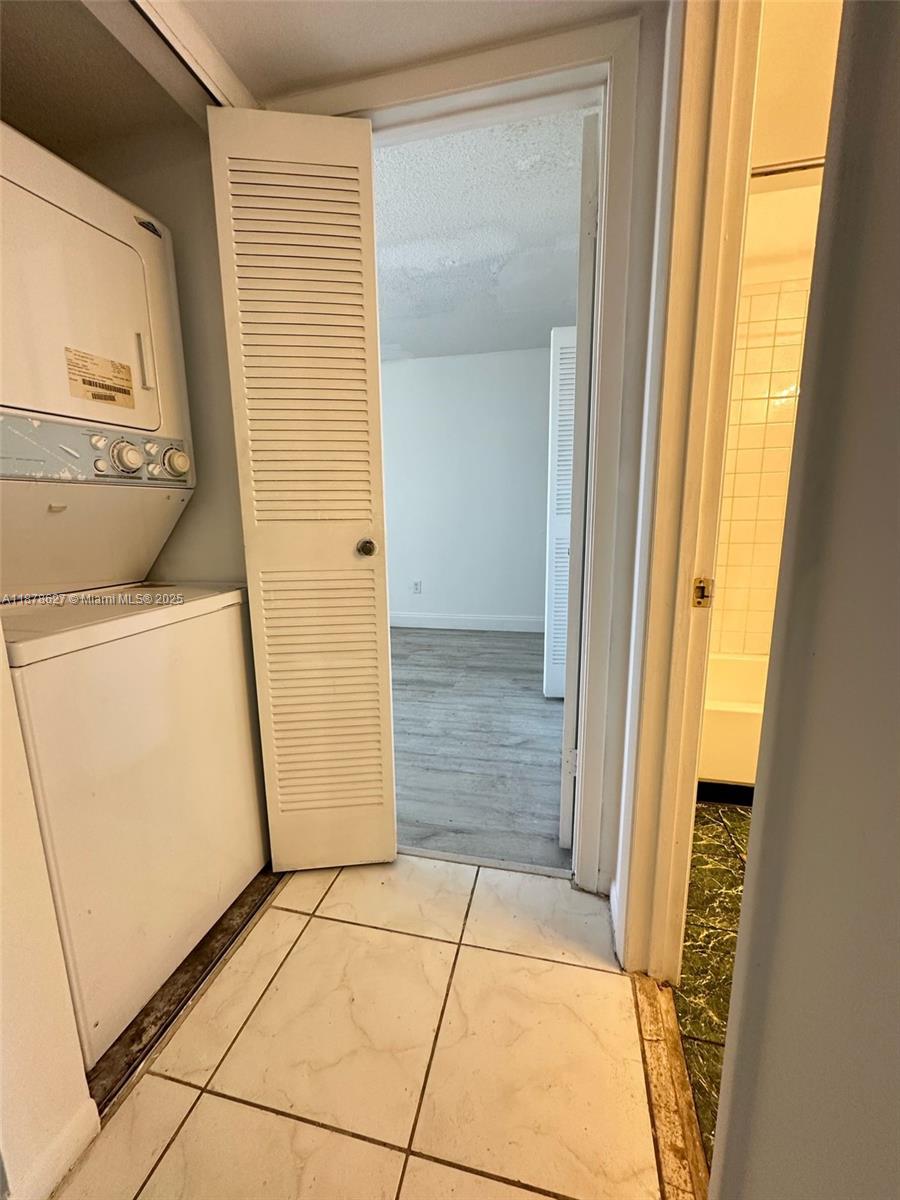 861 Northeast 209th Terrace, Unit 203 Miami, FL 33179 - Photo 7 of 16 a bathroom with a granite countertop shower and a mirror