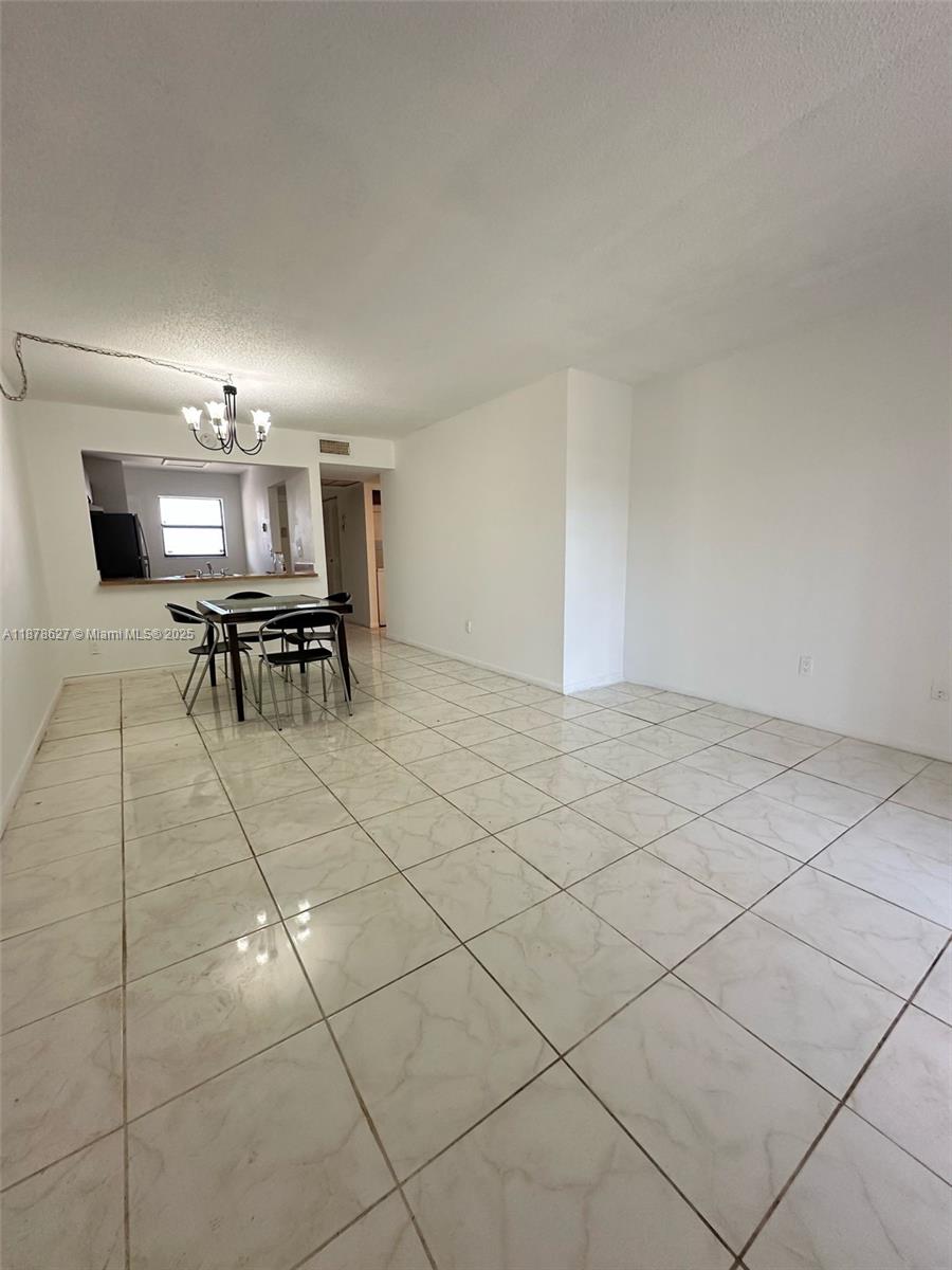 861 Northeast 209th Terrace, Unit 203 Miami, FL 33179 - Photo 10 of 16 a view of a dining room with furniture
