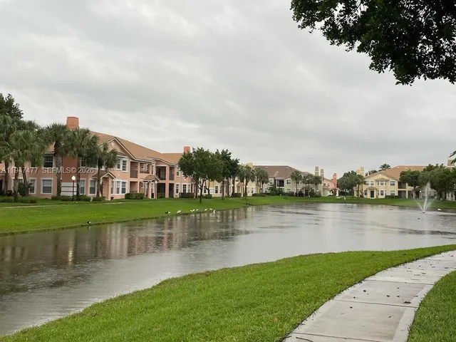 a view of a lake with houses in the back