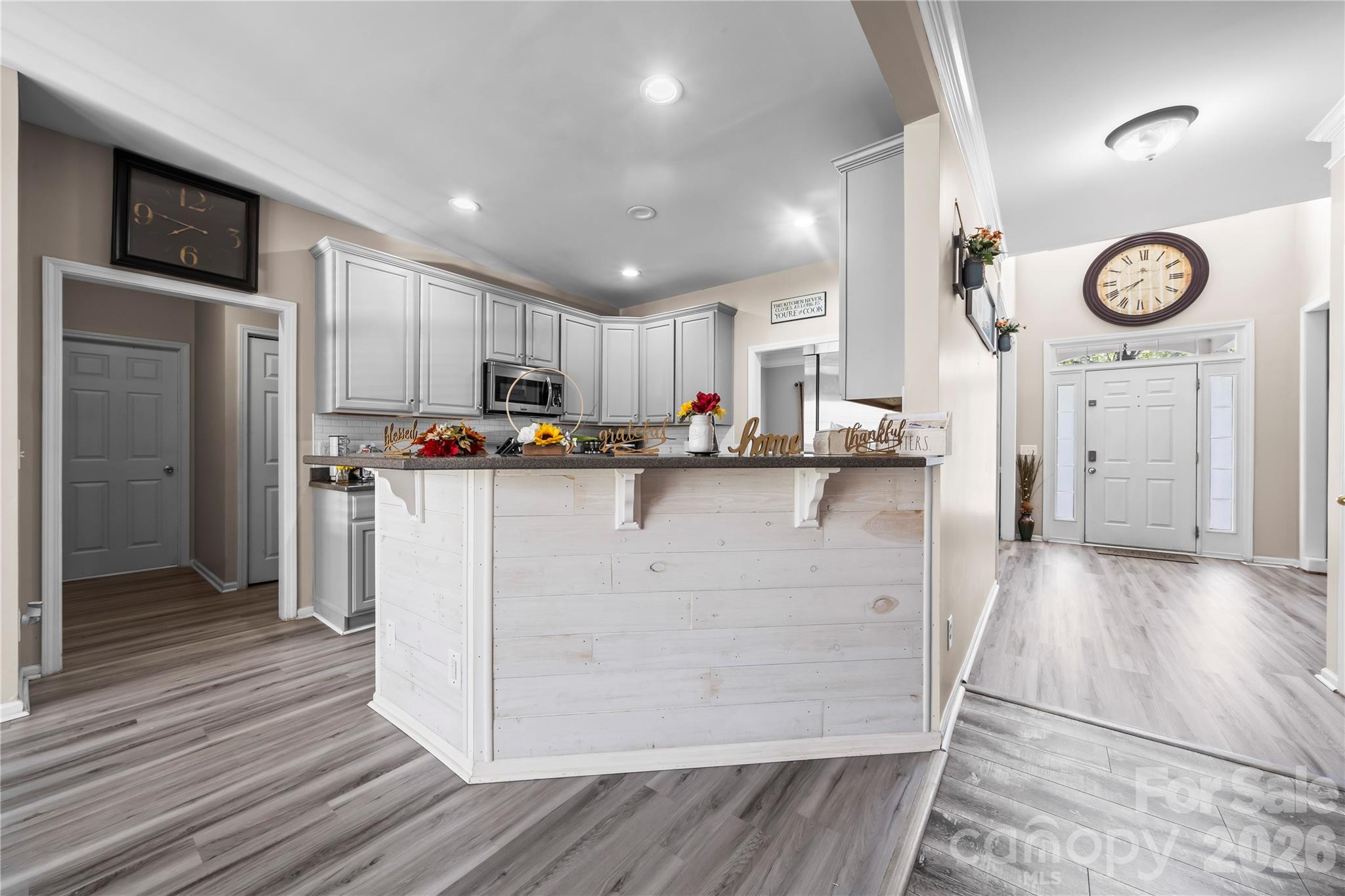 3715 Messina Road Clover, SC 29710 - Photo 8 of 33 a kitchen with kitchen island white cabinets stainless steel appliances and wooden floor