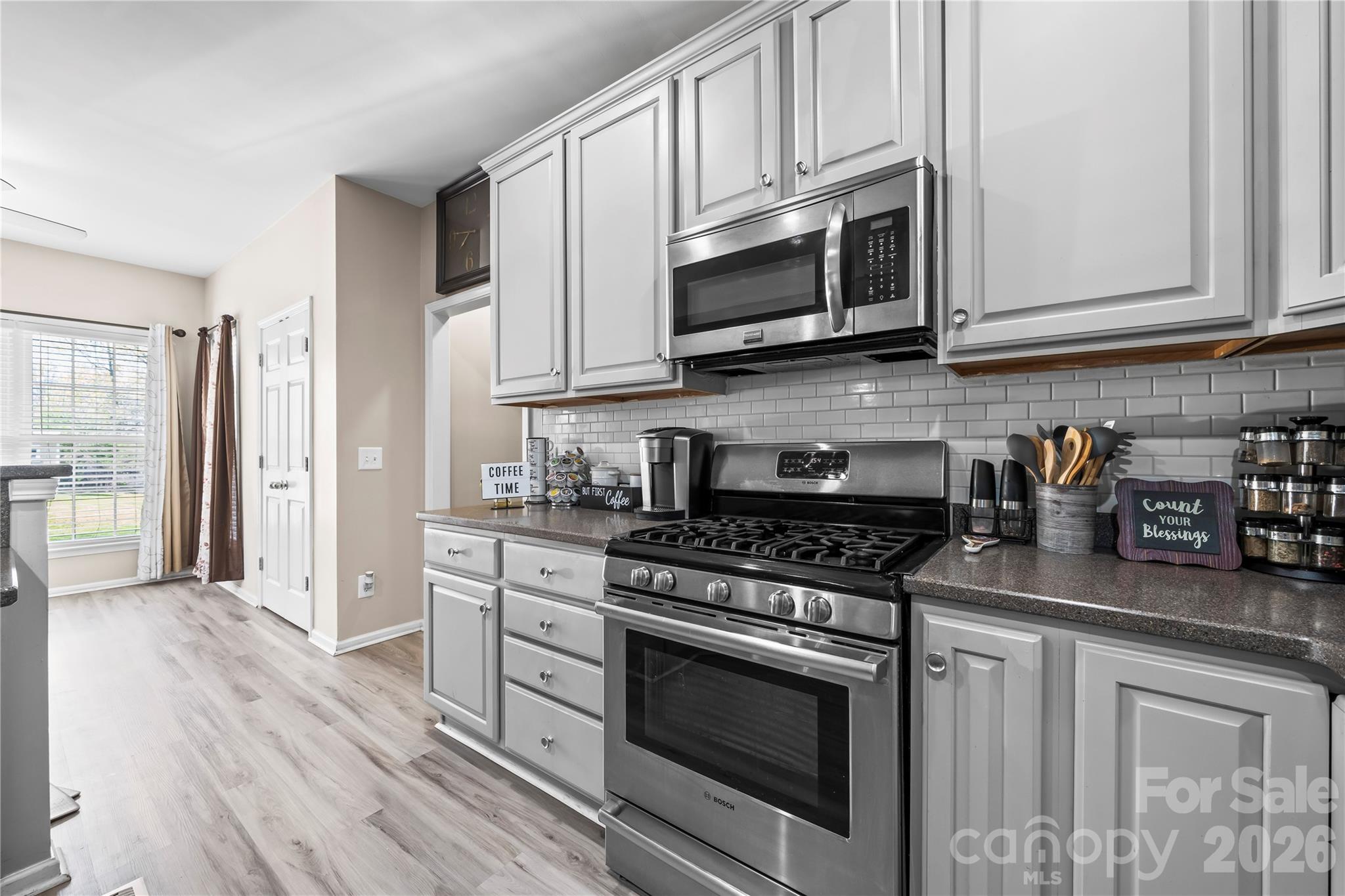 3715 Messina Road Clover, SC 29710 - Photo 10 of 33 a kitchen with stainless steel appliances granite countertop a stove a microwave and cabinets