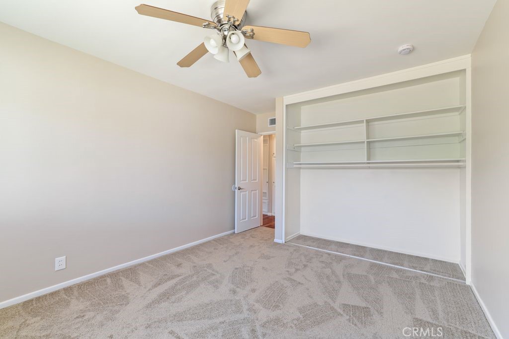 14802 Springford Drive La Mirada, CA 90638 - Photo 11 of 26 an empty room with a empty space and a ceiling fan