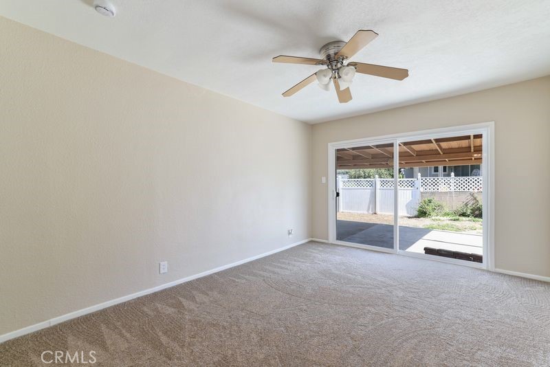 14802 Springford Drive La Mirada, CA 90638 - Photo 12 of 26 an empty room with window and ceiling fan