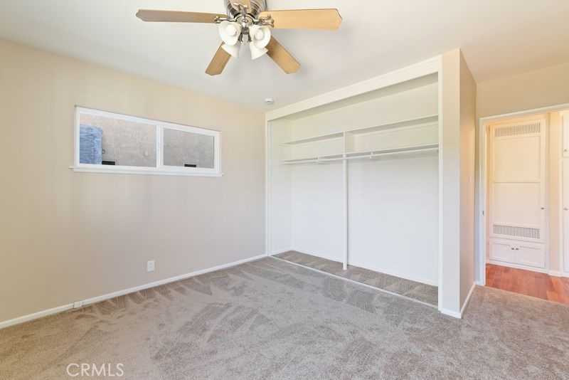 14802 Springford Drive La Mirada, CA 90638 - Photo 14 of 26 an empty room with a chandelier fan