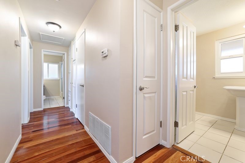 14802 Springford Drive La Mirada, CA 90638 - Photo 18 of 26 a view of a hallway with wooden floor and a bathroom