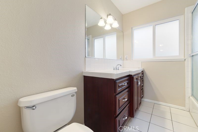 14802 Springford Drive La Mirada, CA 90638 - Photo 19 of 26 a bathroom with a sink vanity and a toilet