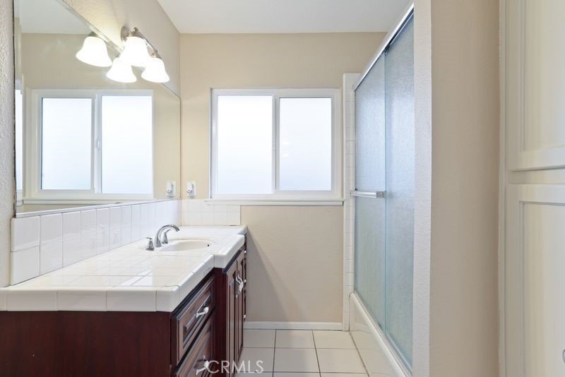 14802 Springford Drive La Mirada, CA 90638 - Photo 20 of 26 a bathroom with a sink a vanity and a mirror