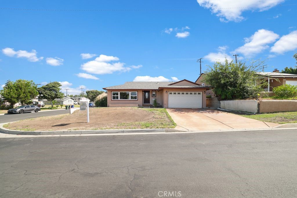 14802 Springford Drive La Mirada, CA 90638 - Photo 2 of 26 a front view of a house with a yard and a garage