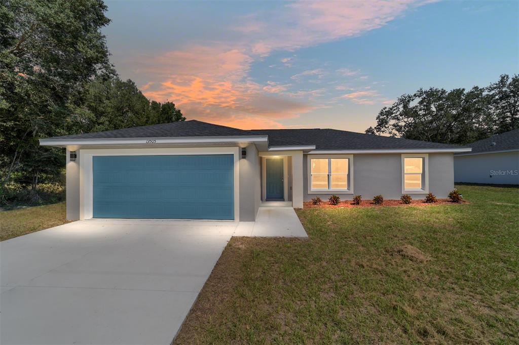13505 Southwest 112th Place Dunnellon, FL 34432 - Photo 1 of 1 a front view of a house with yard and garage