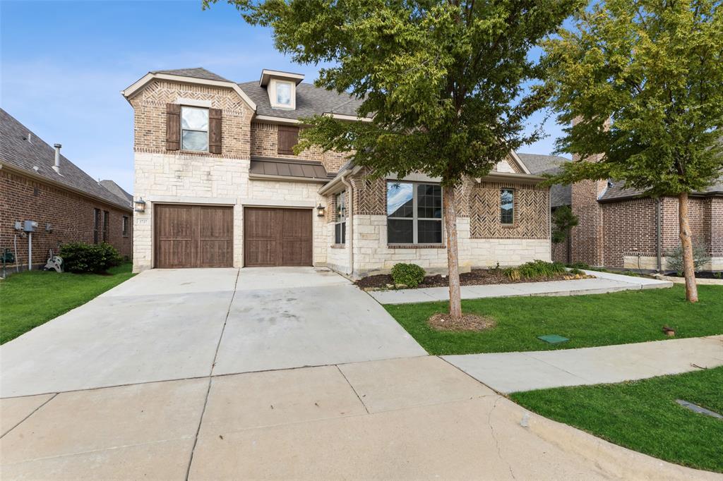 3737 Nottingham The Colony, TX 75056 - Photo 2 of 34 a front view of a house with a yard and garage