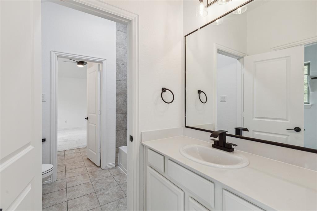 3737 Nottingham The Colony, TX 75056 - Photo 28 of 34 a bathroom with a sink a toilet and a mirror
