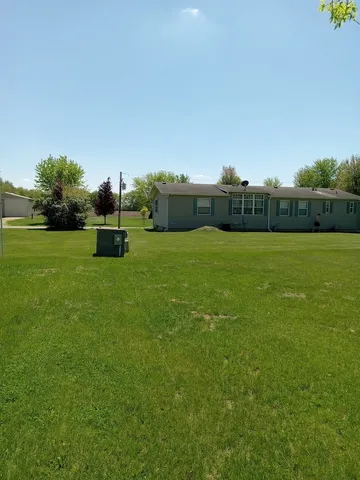 a car parked in the grass near a house