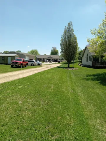 a view of a field with an trees in the background