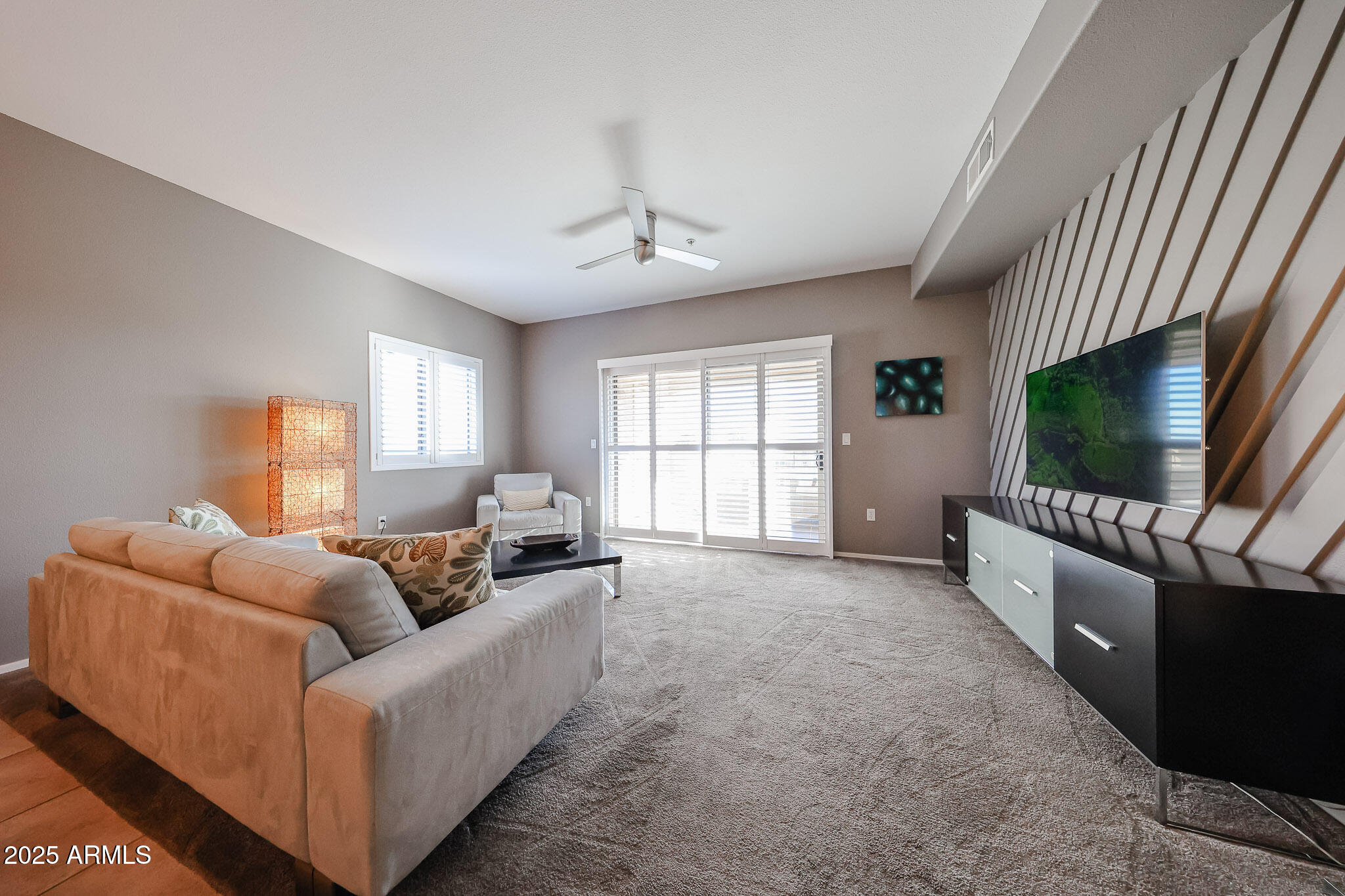 920 East Devonshire Avenue, Unit 4001 Phoenix, AZ 85014 - Photo 17 of 38 a living room with furniture and a flat screen tv