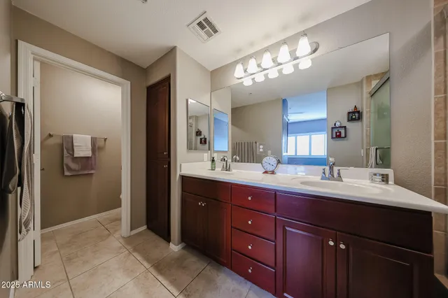 a bathroom with a sink vanity and a mirror