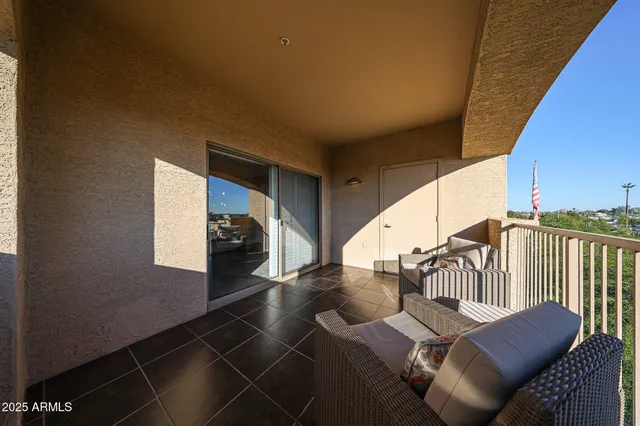 a living room with furniture and a floor to ceiling window