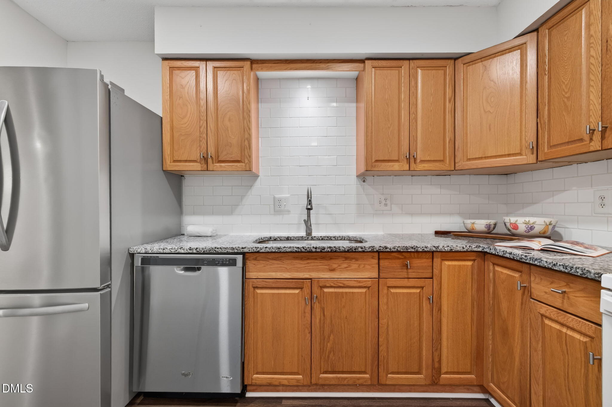 546 Pine Ridge Place Raleigh, NC 27609 - Photo 7 of 21 a kitchen with stainless steel appliances granite countertop a refrigerator sink and cabinets