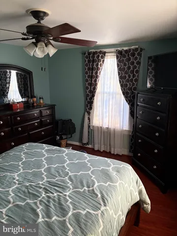 a bedroom with a bed dresser and a window