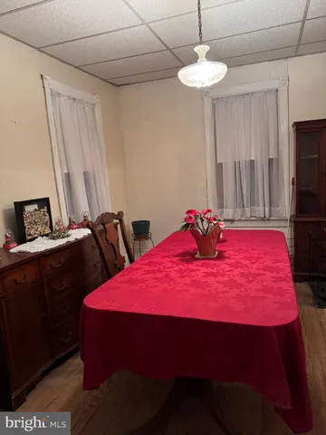 a view of a room with a table chairs and a bed