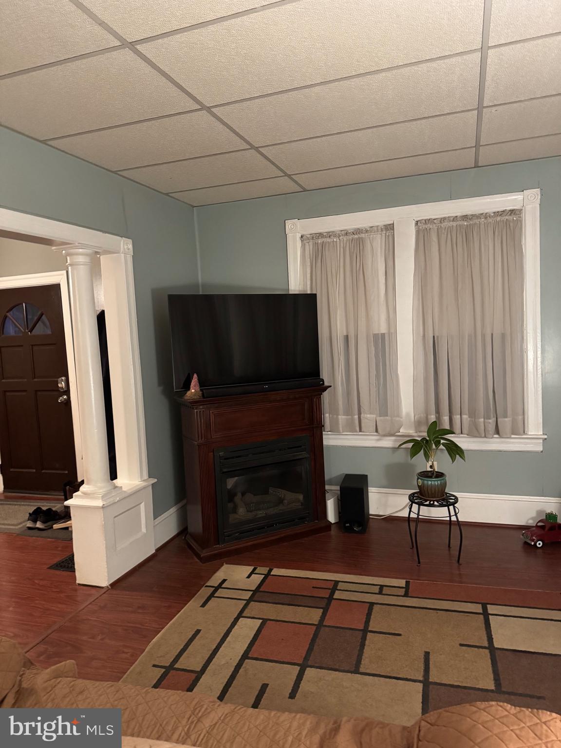 323 West 4th Street Florence, NJ 08518 - Photo 4 of 15 a living room with furniture a fireplace and a flat screen tv