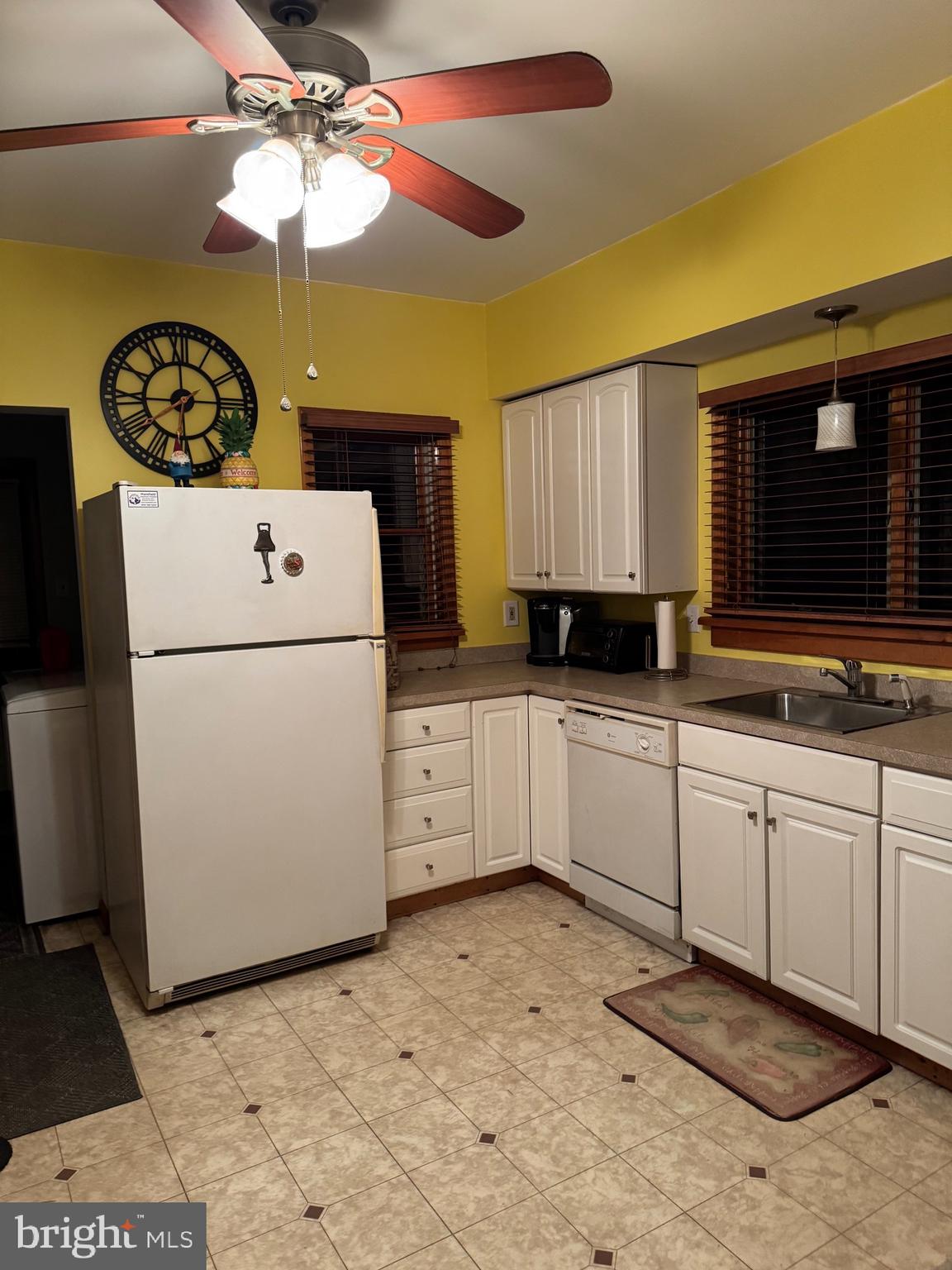323 West 4th Street Florence, NJ 08518 - Photo 5 of 15 a kitchen with a refrigerator a stove a microwave and cabinets