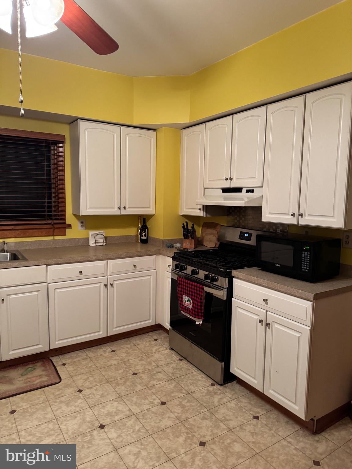 323 West 4th Street Florence, NJ 08518 - Photo 6 of 15 a kitchen with granite countertop a stove a sink and a microwave