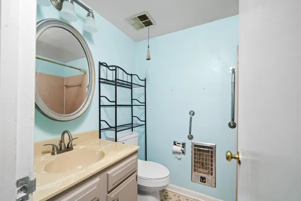 a bathroom with a sink a toilet and a mirror