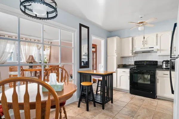 a kitchen with stainless steel appliances kitchen island granite countertop a stove a sink and a refrigerator