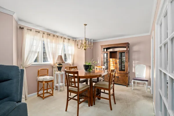 a view of a dining room with furniture and window