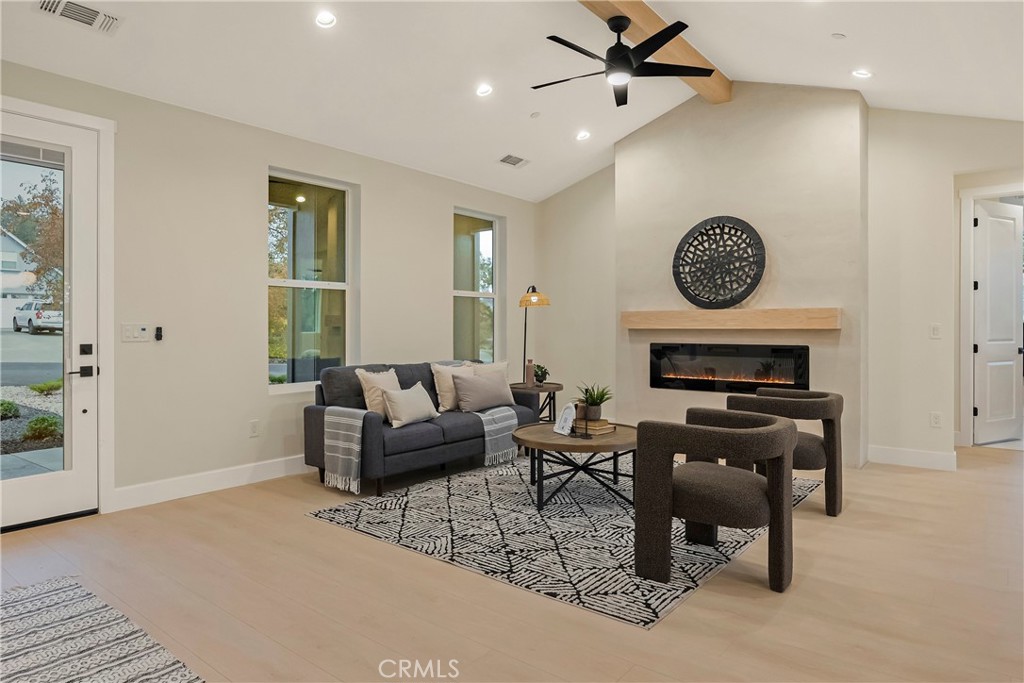 1560 Elliott Road Paradise, CA 95969 - Photo 14 of 50 a living room with furniture a clock on wall and a window