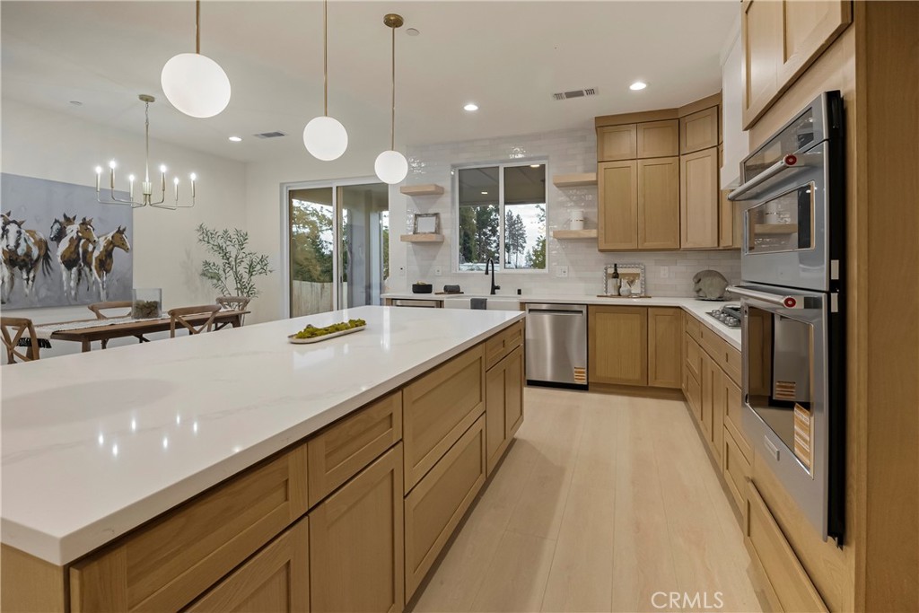 1560 Elliott Road Paradise, CA 95969 - Photo 18 of 50 a large kitchen with a large counter space cabinets a sink and stainless steel appliances