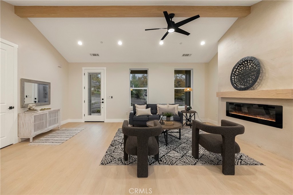 1560 Elliott Road Paradise, CA 95969 - Photo 21 of 50 a living room with furniture a clock and a fireplace