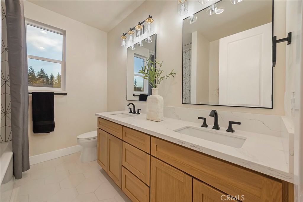 1560 Elliott Road Paradise, CA 95969 - Photo 24 of 50 a bathroom with a double vanity sink and mirror