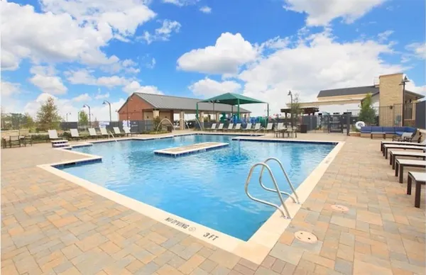 a view of a swimming pool with outdoor seating