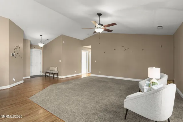 a view of a room with wooden floor and chandelier