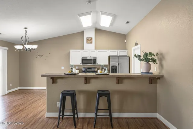 a kitchen with a sink appliances and cabinets