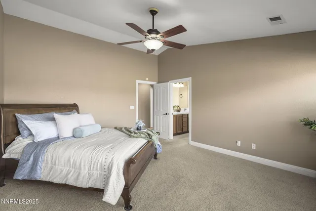 a bathroom with a double vanity sink a large mirror and a bathtub