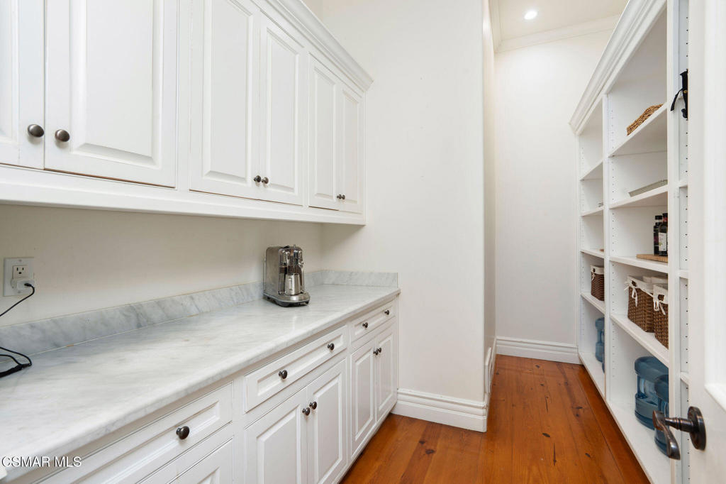 6934 Solano Verde Drive Somis, CA 93066 - Photo 18 of 80 a kitchen with cabinets and a wooden floor