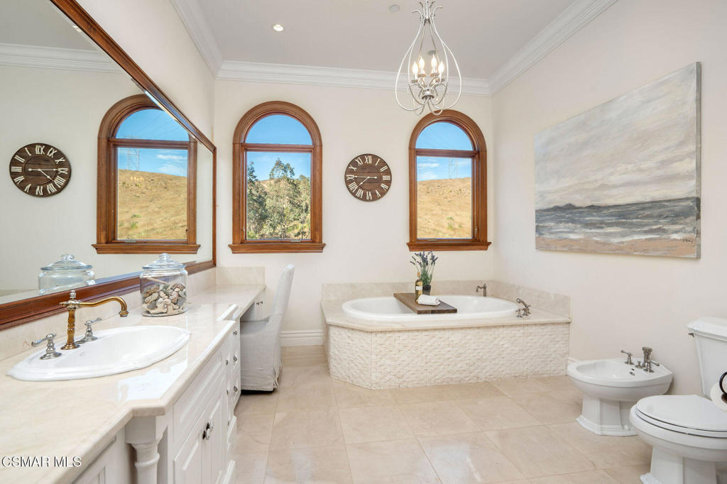 6934 Solano Verde Drive Somis, CA 93066 - Photo 29 of 80 a bathroom with a toilet sink and mirror