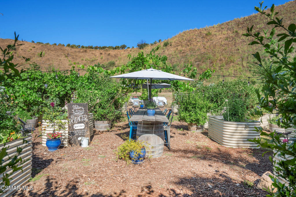 6934 Solano Verde Drive Somis, CA 93066 - Photo 48 of 80 a view of a chairs and table under an umbrella in the terrace
