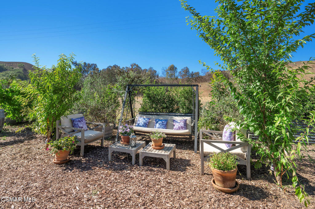 6934 Solano Verde Drive Somis, CA 93066 - Photo 51 of 80 a view of a chair and table in the garden