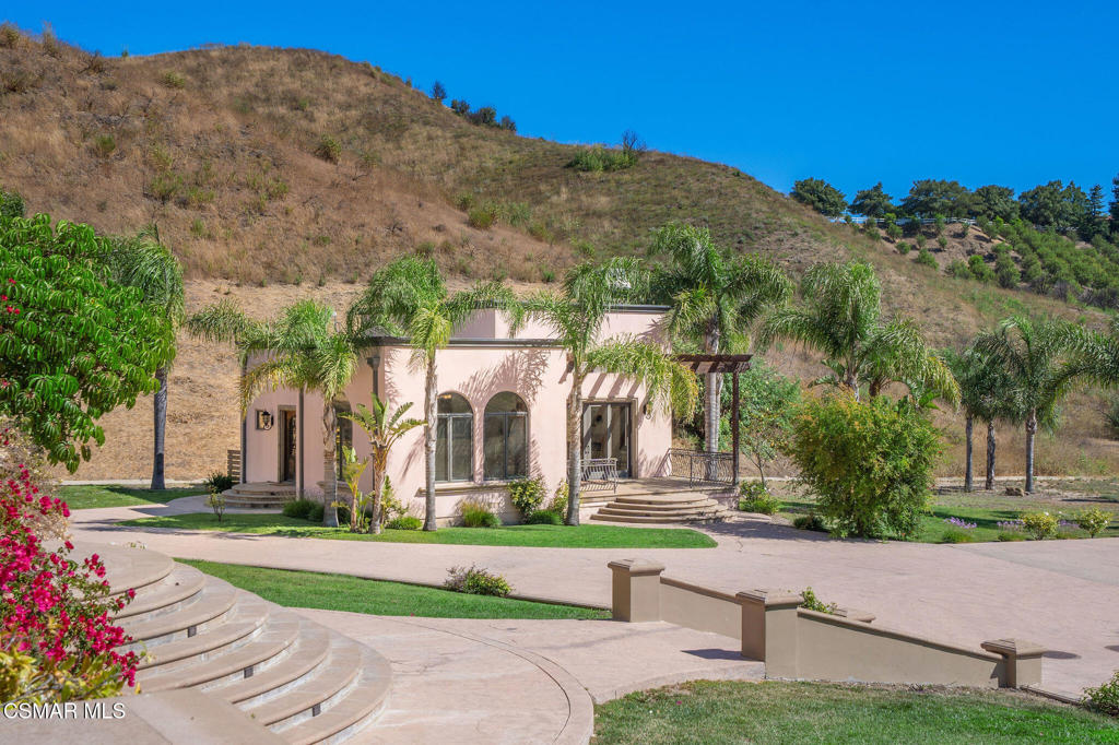 6934 Solano Verde Drive Somis, CA 93066 - Photo 54 of 80 a front view of a house with a yard and palm trees