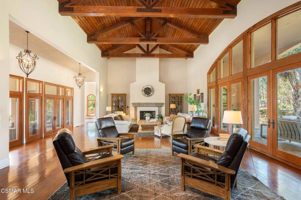 6934 Solano Verde Drive Somis, CA 93066 - Photo 9 of 80 a living room with furniture a fireplace and large windows