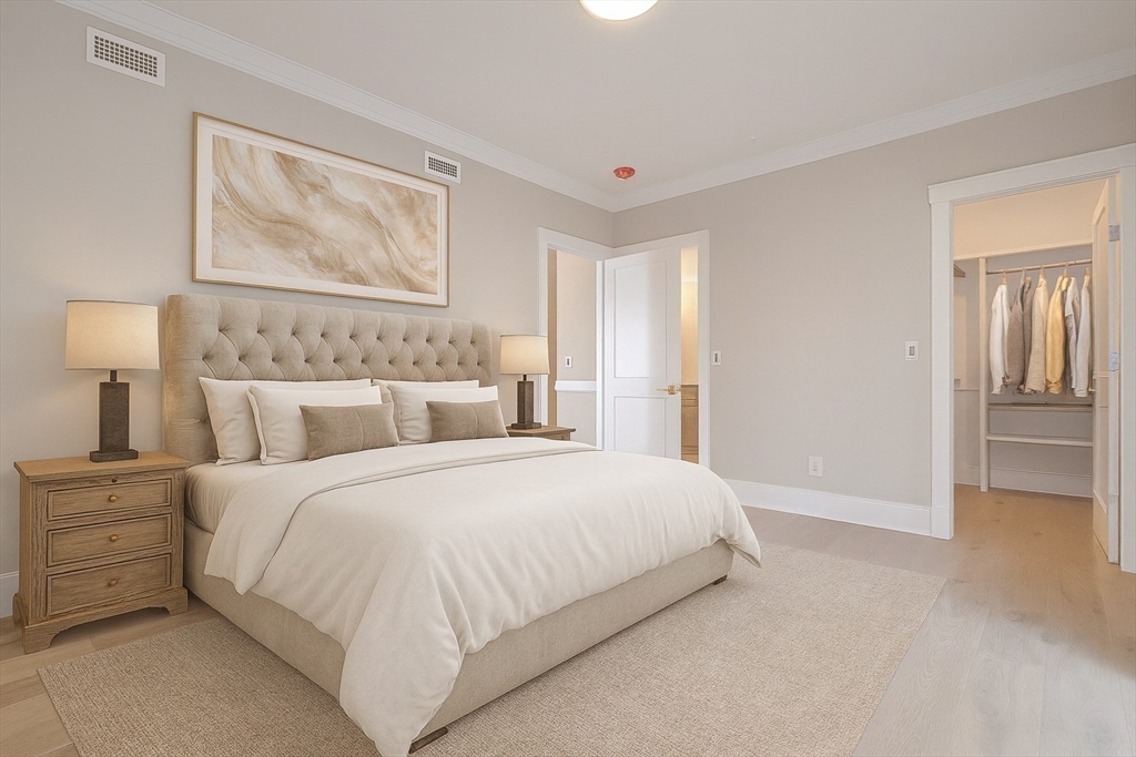 a bedroom with a bed and a painting on the wall