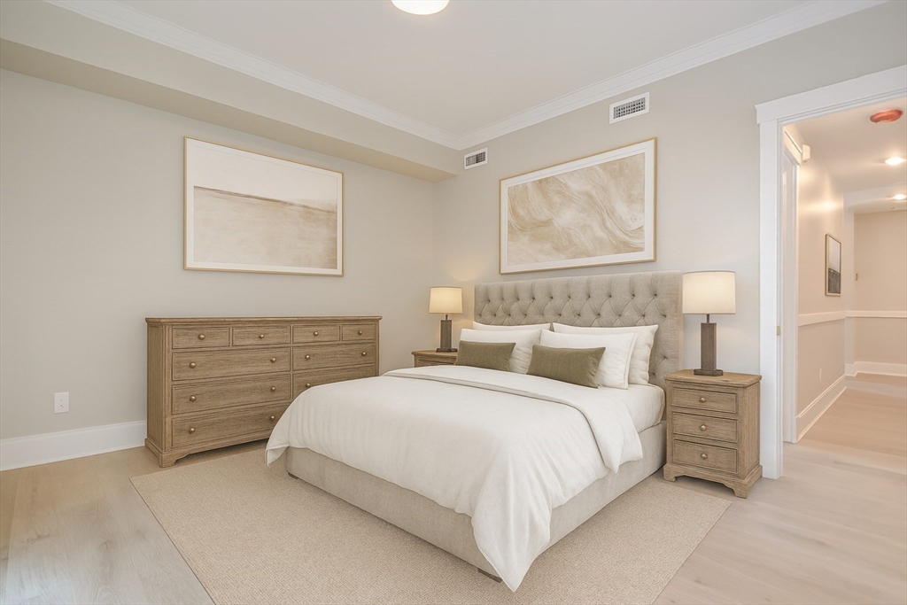 69 Falcon Street, Unit 2 Boston, MA 02128 - Photo 5 of 13 a bedroom with a bed and a painting on the wall