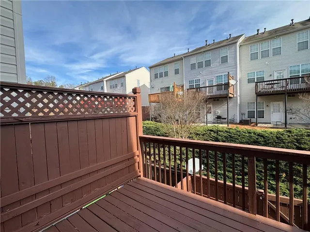 a view of a house with a wooden fence
