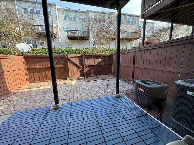 a view of a patio with a chairs and wooden floor