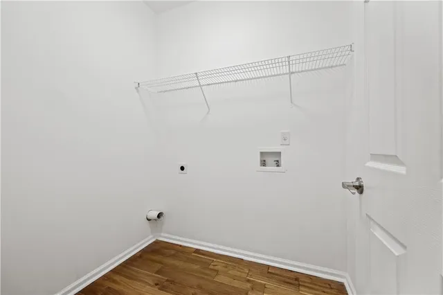 a view of a room with wooden floor