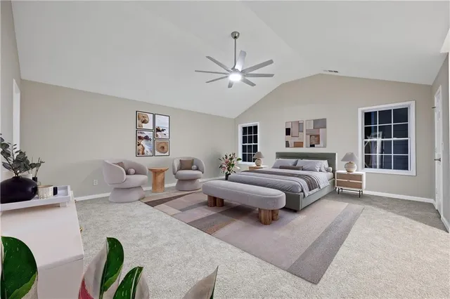 a spacious bedroom with a bed couch and a window